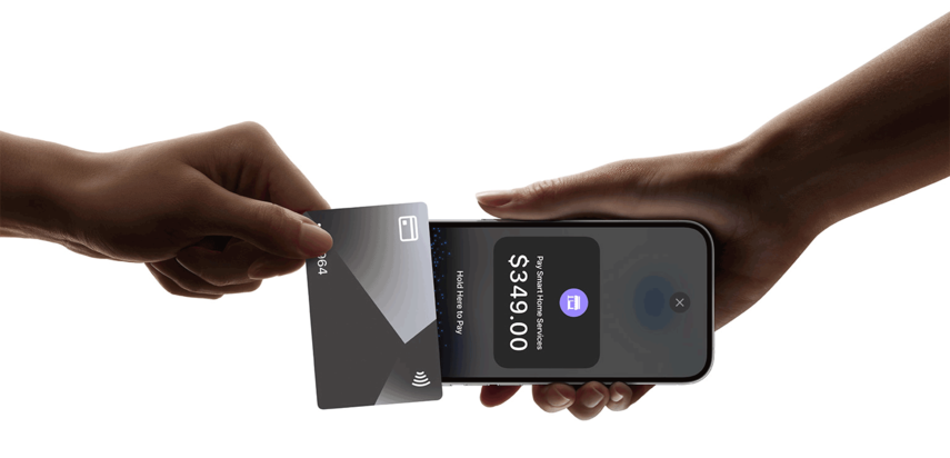 A hand holding a credit card and a phone

Description automatically generated